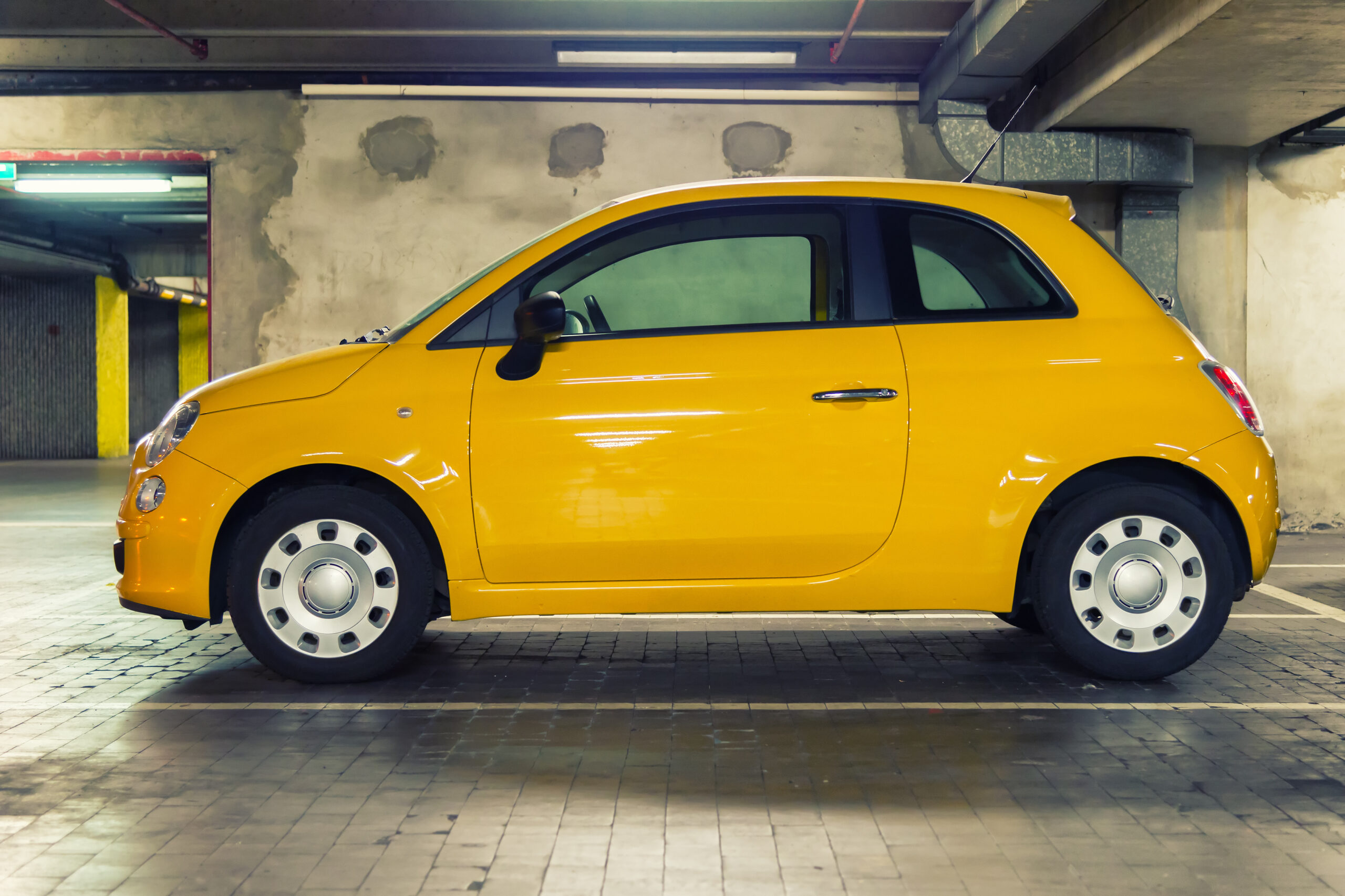 Yellow fiat 500 in parking space